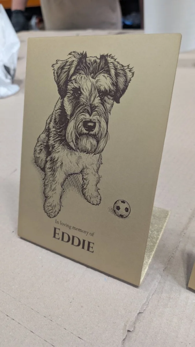 Eddie’s dog portrait etched into a freestanding brass memorial plaque, with dark paint-filled detail and a personalised inscription.